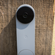 A photo of the Nest Doorbell affixed to a wooden plank